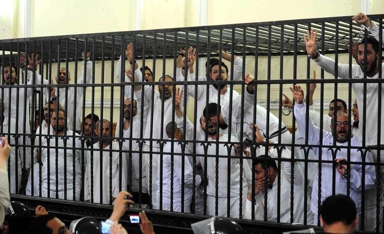 640311-supporters-of-former-egyptian-president-mursi-standing-trial-on-charges-of-violence-react-after-two-